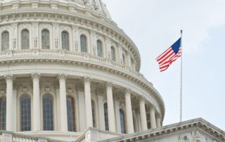 US Capitol with US flag in the foreground