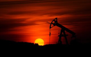 Photo of Pumpjack with red sunset in the background