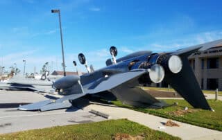 Two fighter jets flipped over in a parking lot after a storm