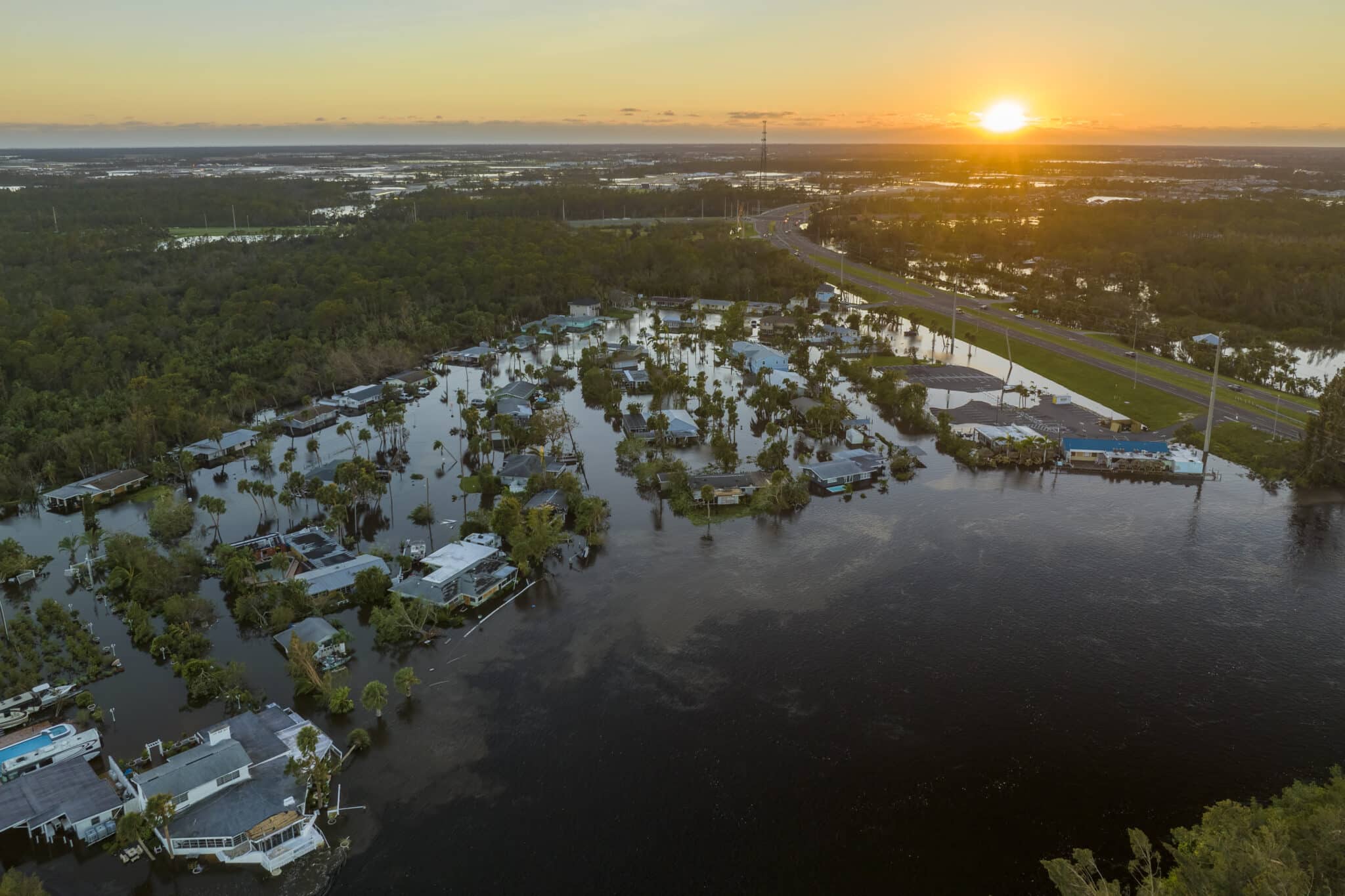 Drone image of a sunset over a flooded residential area in Florida