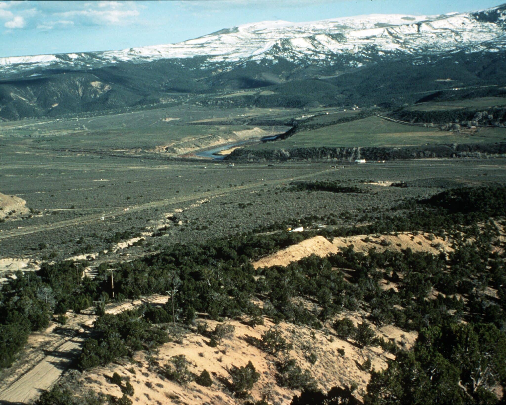 Sprawling field with snow-capped mountain the the back