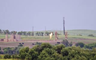 image of a methane flaring facility at dawn