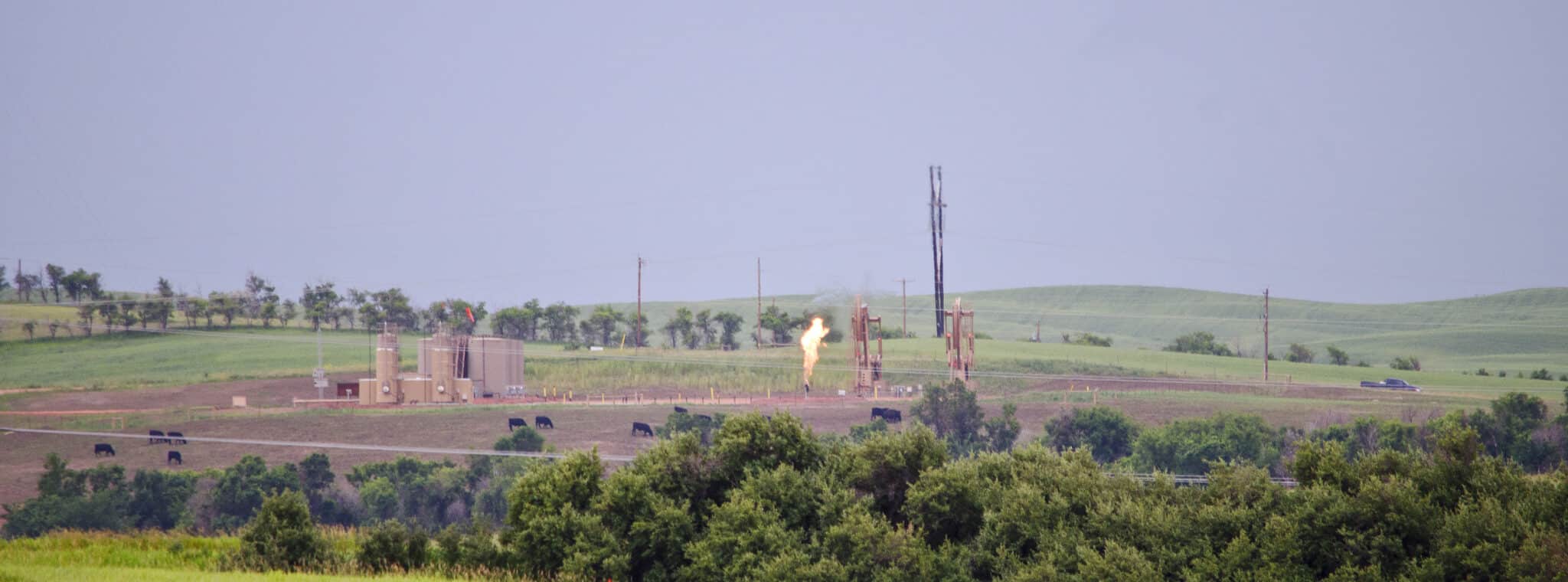 image of a methane flaring facility at dawn