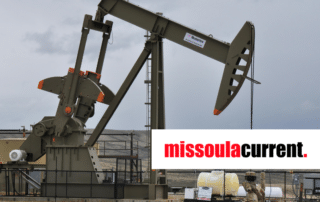 oil pumpjack in front of a cloudy sky in a remote setting