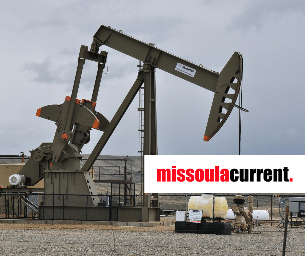 oil pumpjack in front of a cloudy sky in a remote setting